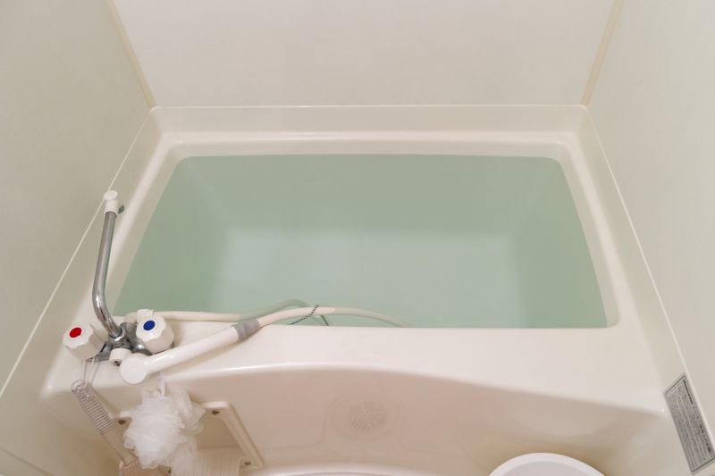 Refinishing professional preparing a bathtub